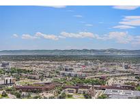 Sweeping aerial view captures the expansive cityscape and mountain views on a sunny day at 1020 15Th St # 42A, Denver, CO 80202