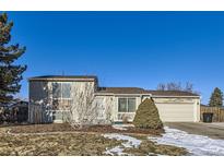 Tan two-story house with attached garage and landscaped yard at 11914 Bellaire Cir, Thornton, CO 80233