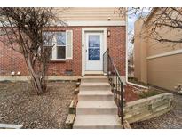 Inviting entrance with stairs leading to the front door of this brick townhome at 1545 S Ouray Cir # A, Aurora, CO 80017