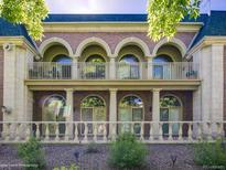 Elegant multi-story home featuring arched windows and a brick facade, complemented by lush greenery at 301 Garfield St # 1E, Denver, CO 80206