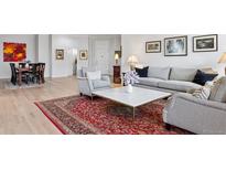 Bright living room features elegant decor, hardwood floors, and an inviting seating arrangement at 301 Garfield St # 1E, Denver, CO 80206