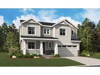 Beautiful two-story home boasts stylish siding, a covered porch, and an attached two-car garage at 24990 E 42Nd Ave, Aurora, CO 80019