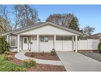 Charming home featuring a well-maintained front yard, a covered parking area, and a classic white exterior at 4350 S Delaware St, Englewood, CO 80110