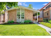 Charming brick home featuring a lush lawn and well-maintained landscaping, creating excellent curb appeal at 1622 Monroe St, Denver, CO 80206