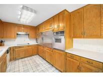 Traditional kitchen with wooden cabinets and stainless steel appliances at 3900 Garland St, Wheat Ridge, CO 80033