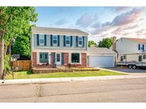 Charming two-story home with blue shutters, brick accents, and a well-maintained front lawn at 12234 W Saratoga Ave, Morrison, CO 80465