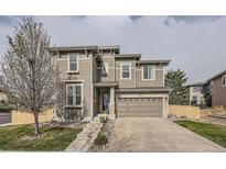 Charming two-story home features a stone-accented facade and attached two-car garage at 5572 Fullerton Cir, Highlands Ranch, CO 80130