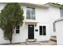 Charming two-story home with a striking black front door and well-maintained landscaping at 3073 W Center Ave # C, Denver, CO 80219