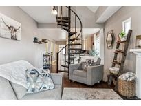 Inviting living room featuring a spiral staircase and hardwood floors with stylish décor, and comfortable seating at 1194 S Washington St, Denver, CO 80210