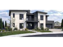 Modern two-story home featuring a balcony, dark framed windows, light colored siding, and lush landscaping at 5358 Lions Paw St, Castle Rock, CO 80104