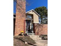Charming townhome with brick accent, stone steps, and a sunny front entrance at 11886 Elk Head Range Rd, Littleton, CO 80127