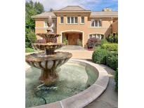 Elegant two-story home with fountain and manicured landscaping at 2 Cherry Hills Farm Dr, Cherry Hills Village, CO 80113