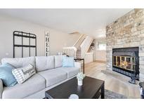 Inviting living room features a stone fireplace, neutral tones, and lots of natural light at 1011 Milo Cir # A, Lafayette, CO 80026