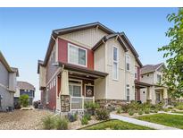 Charming two-story home featuring a landscaped yard and welcoming front porch at 17855 E 103Rd Ave, Commerce City, CO 80022