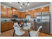 Well-equipped kitchen featuring stainless steel appliances, granite countertops, and a functional layout for cooking and entertaining at 1841 S Dunkirk St # 203, Aurora, CO 80017