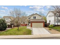 Charming two-story home featuring a well-maintained front yard and attached two-car garage at 5174 S Ukraine St, Aurora, CO 80015