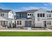 Beautiful two-story home with blue accents, stone trim, and manicured landscaping at 8894 Yellowcress St, Littleton, CO 80125