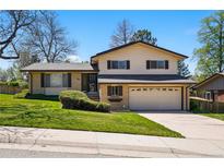 Charming two-story home with a well-manicured lawn and an attached two-car garage at 7590 E Easter Pl, Centennial, CO 80112