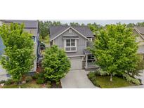 Charming two-story home with gray siding, well-manicured landscaping, and an attached two-car garage at 1867 W 137Th Ln, Broomfield, CO 80023