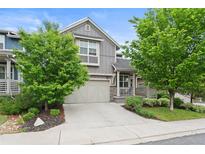 Charming home featuring a well-manicured lawn and inviting front porch, blending curb appeal with a welcoming atmosphere at 1867 W 137Th Ln, Broomfield, CO 80023