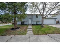 Charming home with mature trees and a well-maintained front yard, showcasing its welcoming curb appeal at 3902 S Uravan St, Aurora, CO 80013