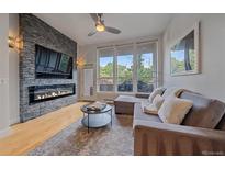 Modern living room boasts a sleek fireplace, large windows, and comfortable seating at 1655 N Williams St, Denver, CO 80218