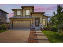 Charming two-story home with landscaped yard, stone accents, and attached two-car garage at 11089 Woodhurst Cir, Highlands Ranch, CO 80130