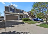 Charming two-story home with a two-car garage and a well-maintained lawn and landscaping at 20826 Robins Dr, Denver, CO 80249
