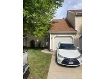 Charming home featuring attached garage, front yard, and quaint walkway at 482 S Kalispell Way # E, Aurora, CO 80017