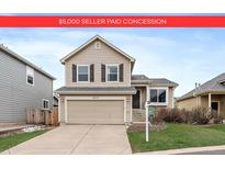 Charming two-story home features a two-car garage and well-maintained front yard at 16175 Peregrine Dr, Parker, CO 80134