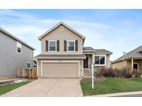 Charming two-story home with a well-maintained lawn and a two-car garage at 16175 Peregrine Dr, Parker, CO 80134