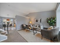 Inviting living room features neutral tones, plush carpet, and ample seating for a comfortable and relaxing atmosphere at 16175 Peregrine Dr, Parker, CO 80134