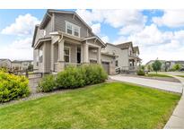 Charming two-story home with landscaped front yard and welcoming covered porch at 4884 St Vrain Rd, Firestone, CO 80504