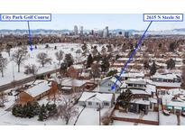 Aerial view of home with City Park Golf Course and Denver skyline in background at 2615 N Steele St, Denver, CO 80205