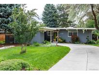 Charming single-story home with a well-manicured lawn and a curved driveway leading to the front entrance at 1338 S Fairfax St, Denver, CO 80222