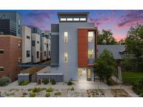 Contemporary home with a grey exterior and a pop of color with an orange section by the entrance at 2922 W 26Th Ave # 1, Denver, CO 80211