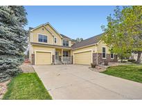 Inviting two-story home with a three-car garage and well-maintained landscaping at 22991 Hope Dale Ave, Parker, CO 80138