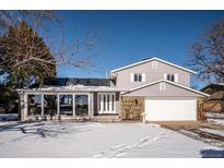 Two-story house with attached garage and snow-covered front yard at 11143 W Ohio Pl, Lakewood, CO 80226