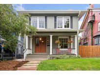 Charming home featuring a welcoming front porch, well-maintained lawn, and traditional architectural details at 1352 N Downing St, Denver, CO 80218