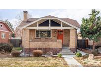 Charming brick home featuring a cozy front porch and well-maintained landscaping at 3370 W Clyde Pl, Denver, CO 80211