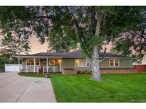 Charming ranch home with mature landscaping and a spacious lawn at 5450 Flower Ct, Arvada, CO 80002