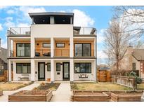 Modern townhome with sleek design, balconies, and a porch swing, set against a blue sky at 3929 Newton St, Denver, CO 80211
