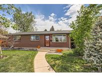 Charming brick home featuring a well-manicured lawn, inviting walkway, and freshly painted trim at 2986 W Union Ave, Englewood, CO 80110