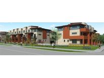 Modern multi-Gathering residences boast stone and wood exteriors, complemented by manicured landscaping, creating a welcoming street view at 9195 Pierce St # 2, Westminster, CO 80021