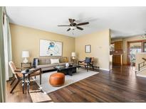 Inviting living room featuring hardwood floors, ceiling fan, and contemporary decor at 845 S Kenton St, Aurora, CO 80012