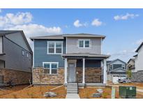 Charming two-story home boasts stone accents, a covered porch, and professional landscaping at 691 N Tempe St, Aurora, CO 80018