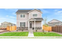 Charming two-story home featuring a well-manicured lawn and appealing stone accents at 691 N Tempe St, Aurora, CO 80018