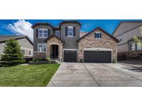 Charming two-story home with a well-manicured lawn, stone accents, and a two-car garage at 6738 Esmeralda Dr, Castle Rock, CO 80108
