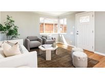 Bright living room with hardwood floors and natural light, creating a warm and inviting atmosphere at 3216 N Saint Paul St, Denver, CO 80205
