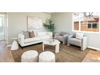 Bright living room with modern decor, plush seating, and ample natural light for a cozy and inviting atmosphere at 3216 N Saint Paul St, Denver, CO 80205